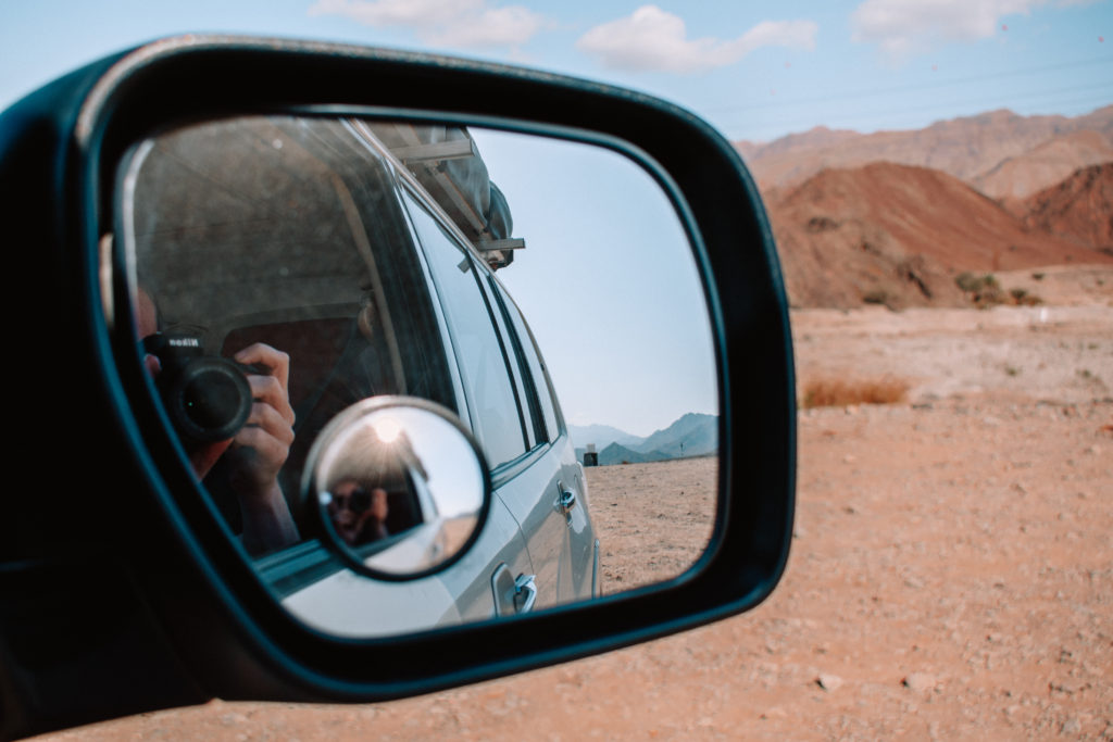 Desert reflected in car wing mirror