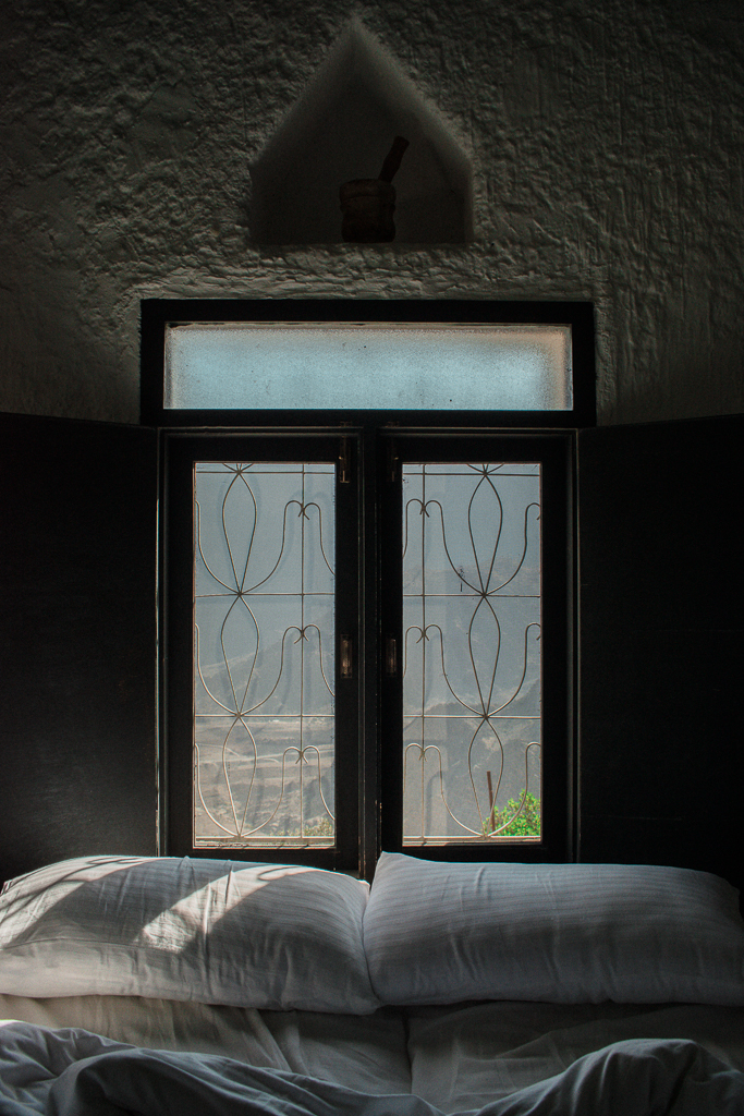 Bed with view over the mountains at Sama Wakan Heritage Hotel
