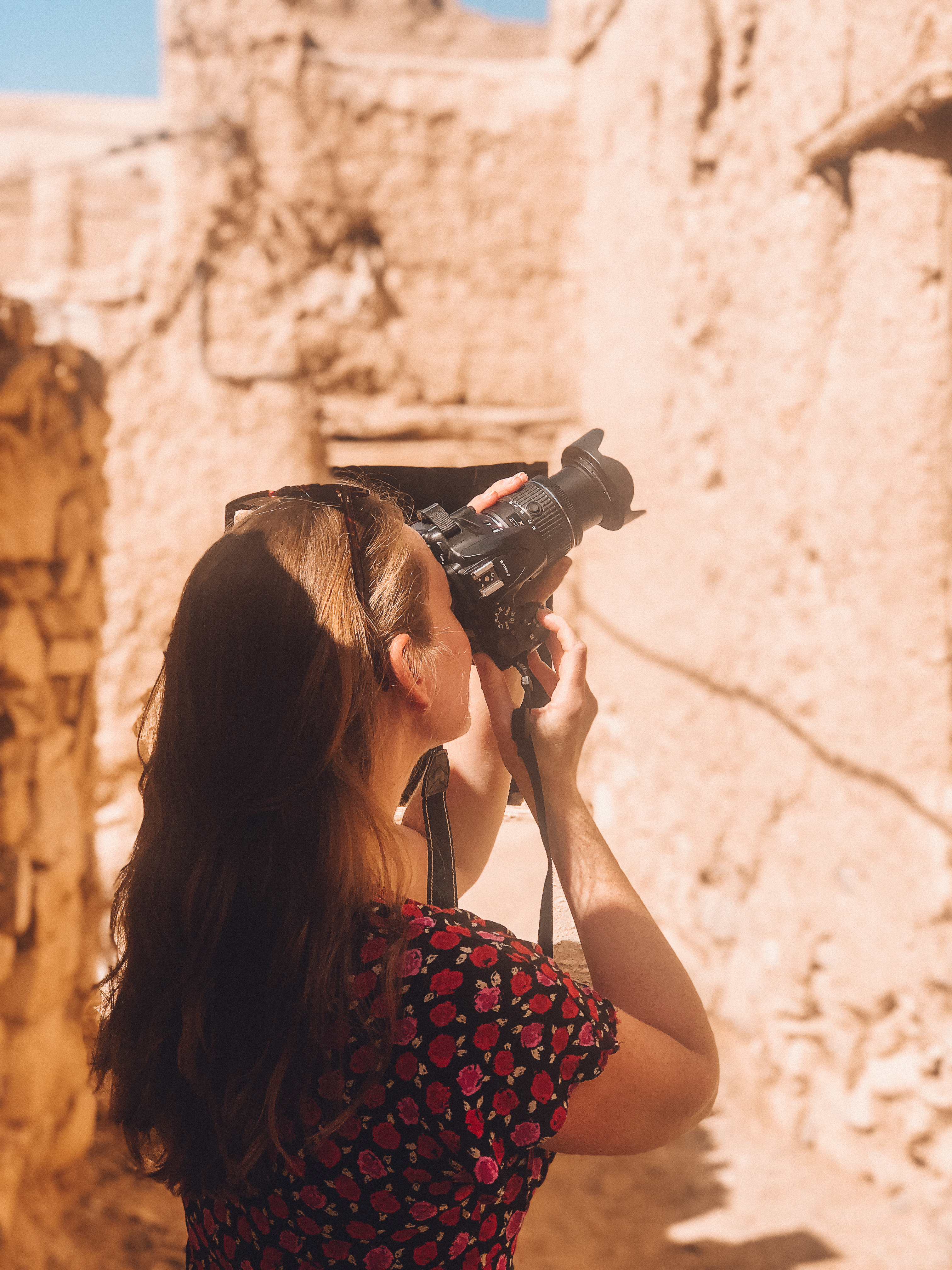 Woman taking a photograph in Oman