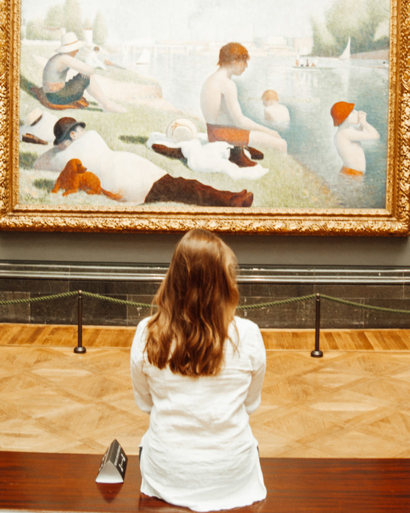 Woman looking at Georges Seurat's Bathers at Asnieres