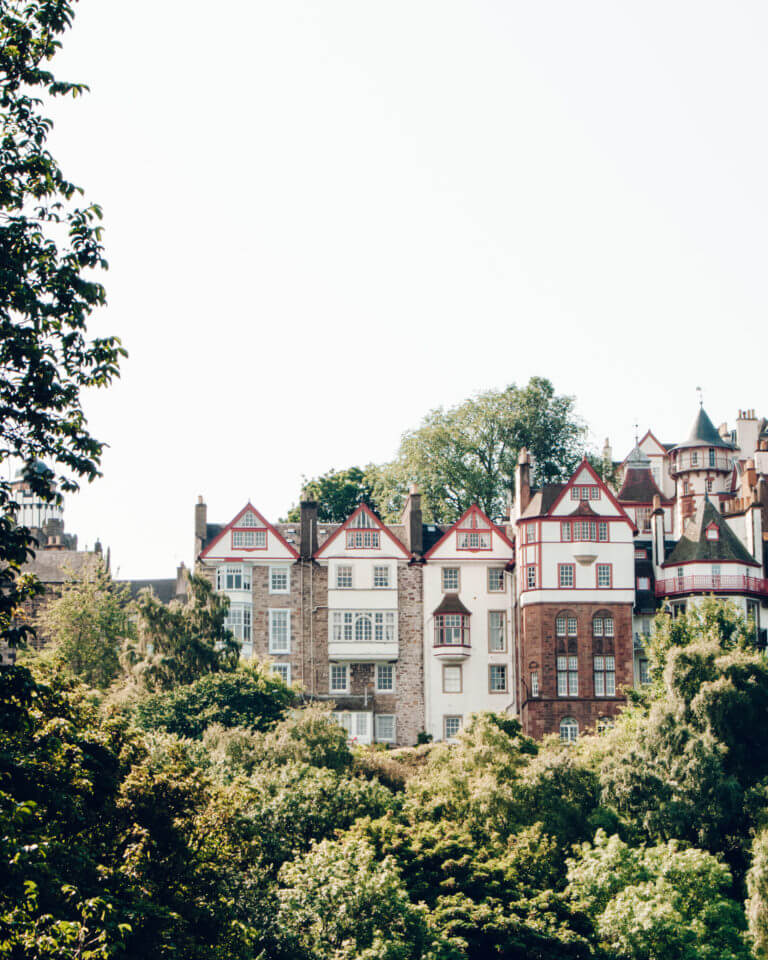 Multicoloured townhouses above a green park