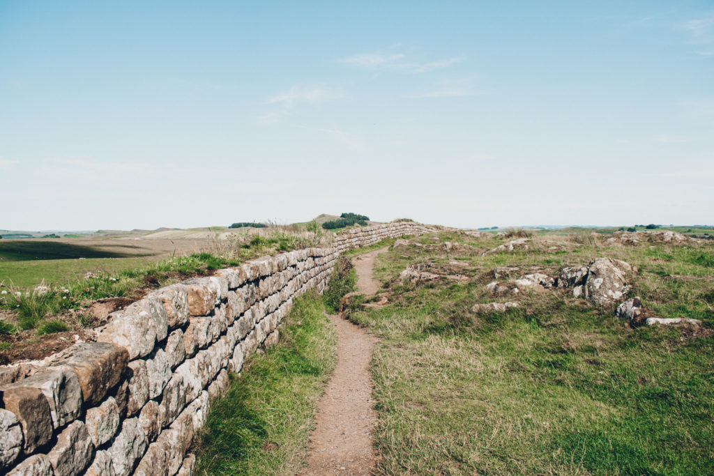 Hiking path next to complete section of Hadrian's Wall
