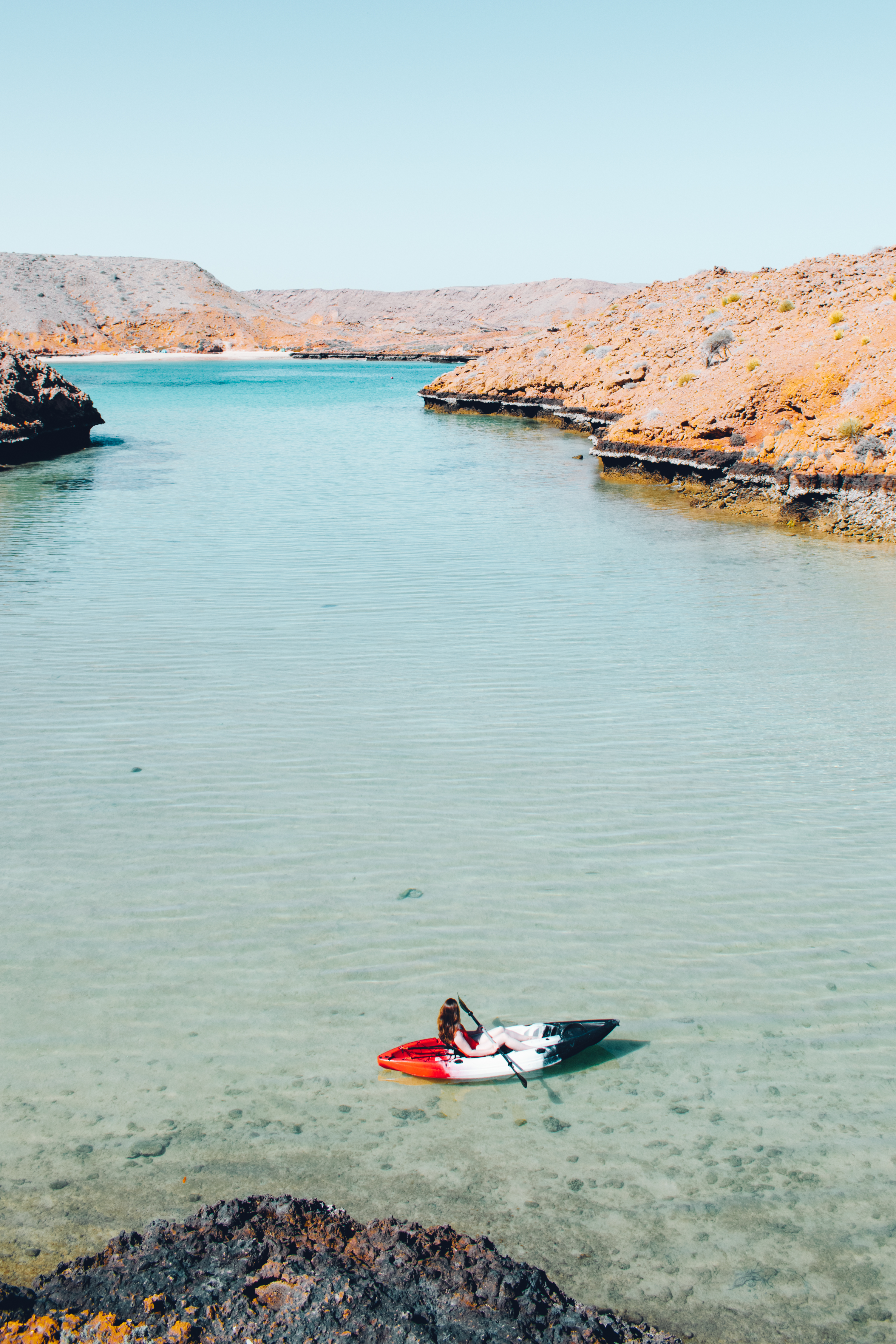 Woman kayaking in a cove at Bandar al Khiran