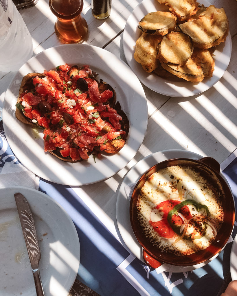 Sun dappled Greek lunch of baked feta, crispy aubergine and tomato toasts