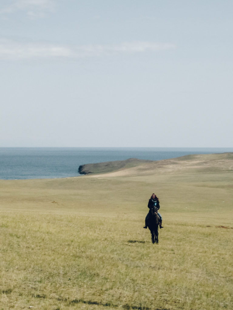 Woman horse riding on Olkhon Island, Lake Baikal, Russia