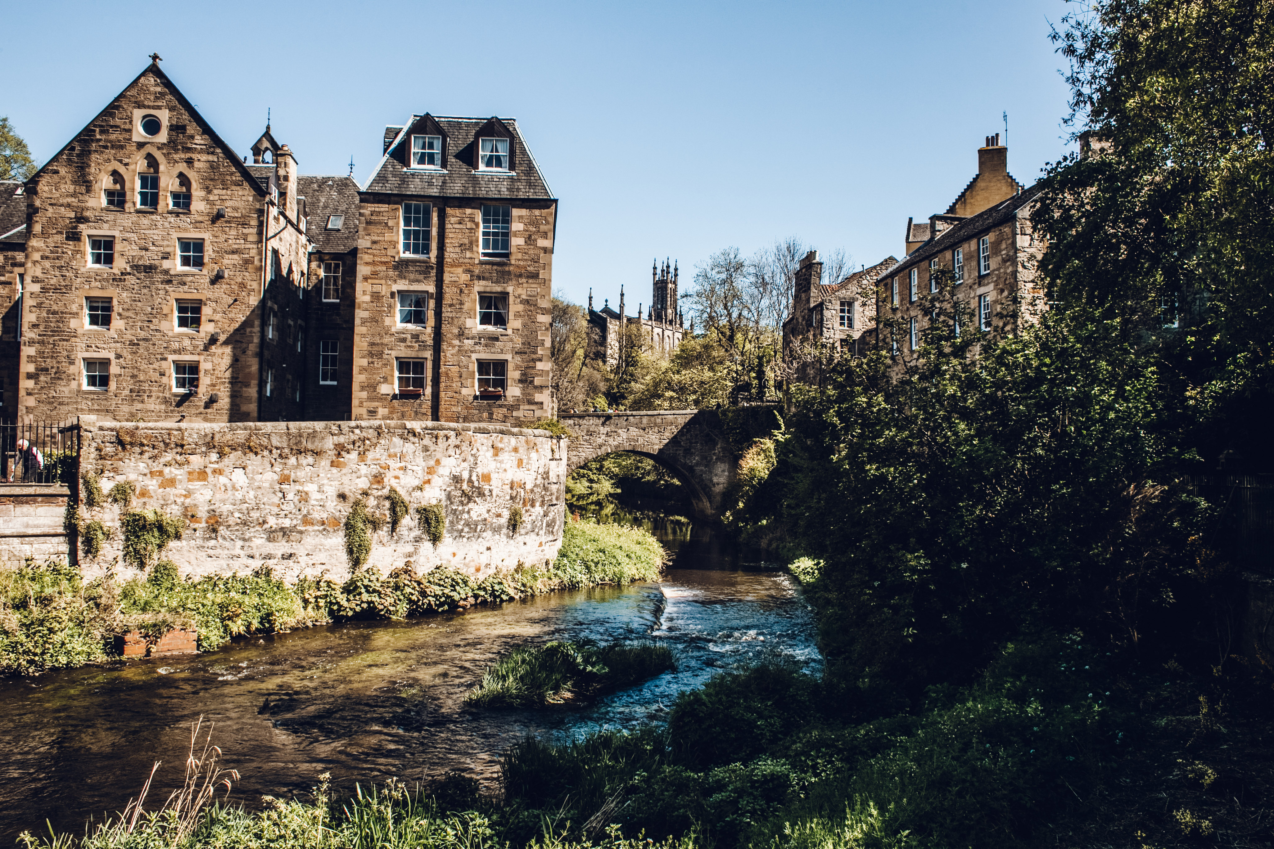 River running past flat blocks in Edinburgh's Dean Village