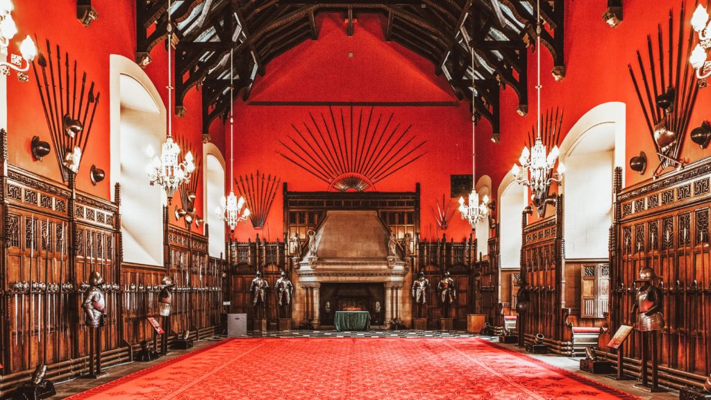 Red and wood panelled wars covered in weapons at Edinburgh Castle