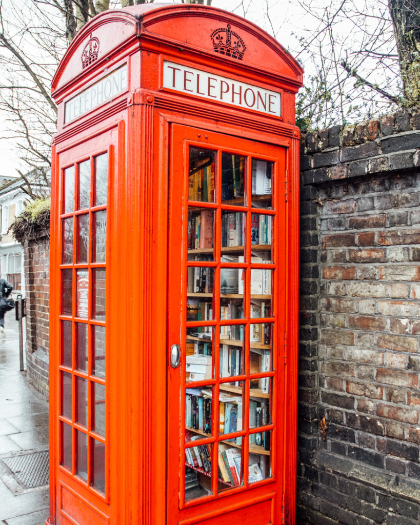 Disused traditional London phone box filled with books in Lewisham