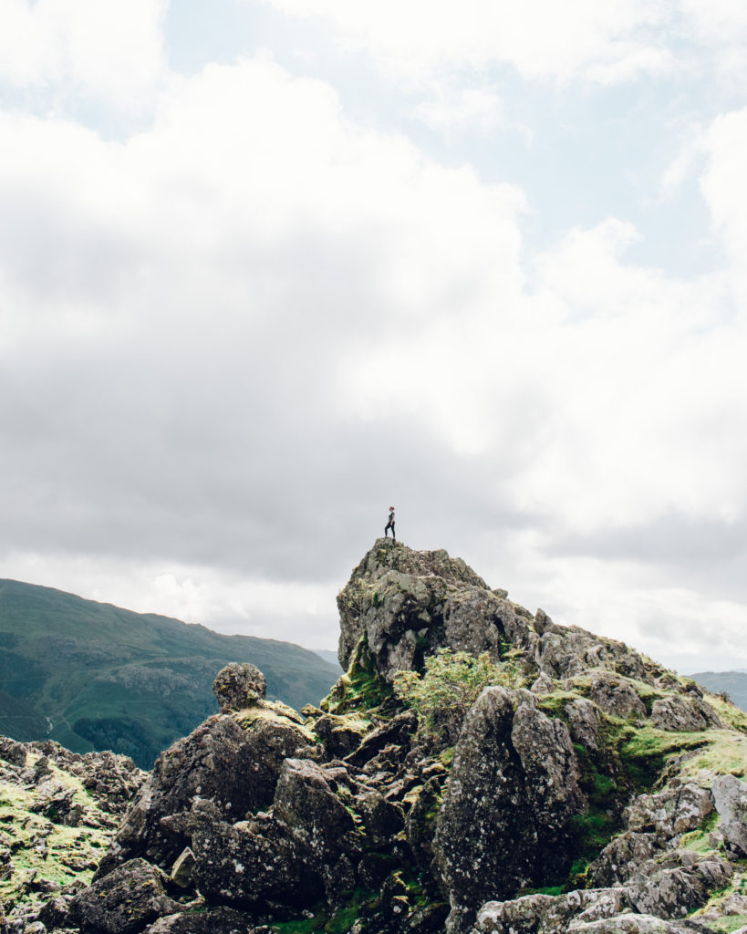 Woman on top of prominent rocky outcrop, Helm Crag