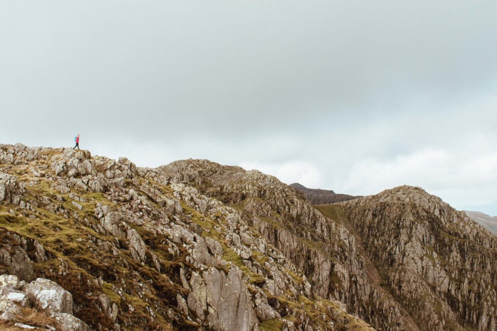 Woman in the distance on a cloudy day on the Crinkle Crag ridge in the Lake District