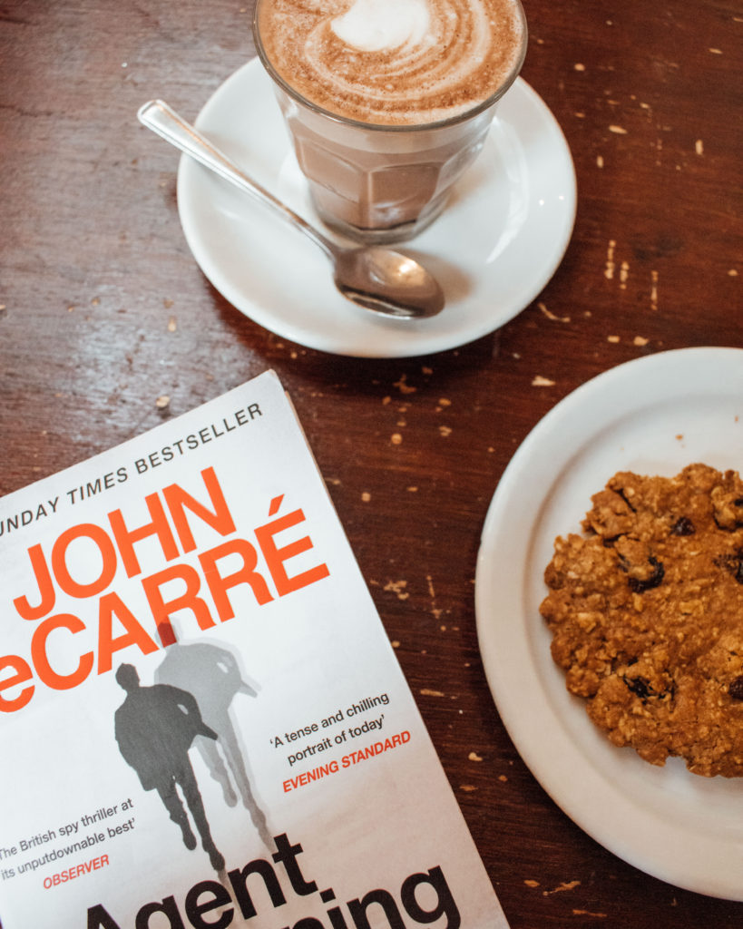 Literary London - flat lay with John Le Carre Novel and cookie at Coffee and Chairs, Fulham