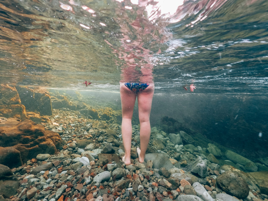 Woman's legs underwater in the River Esk