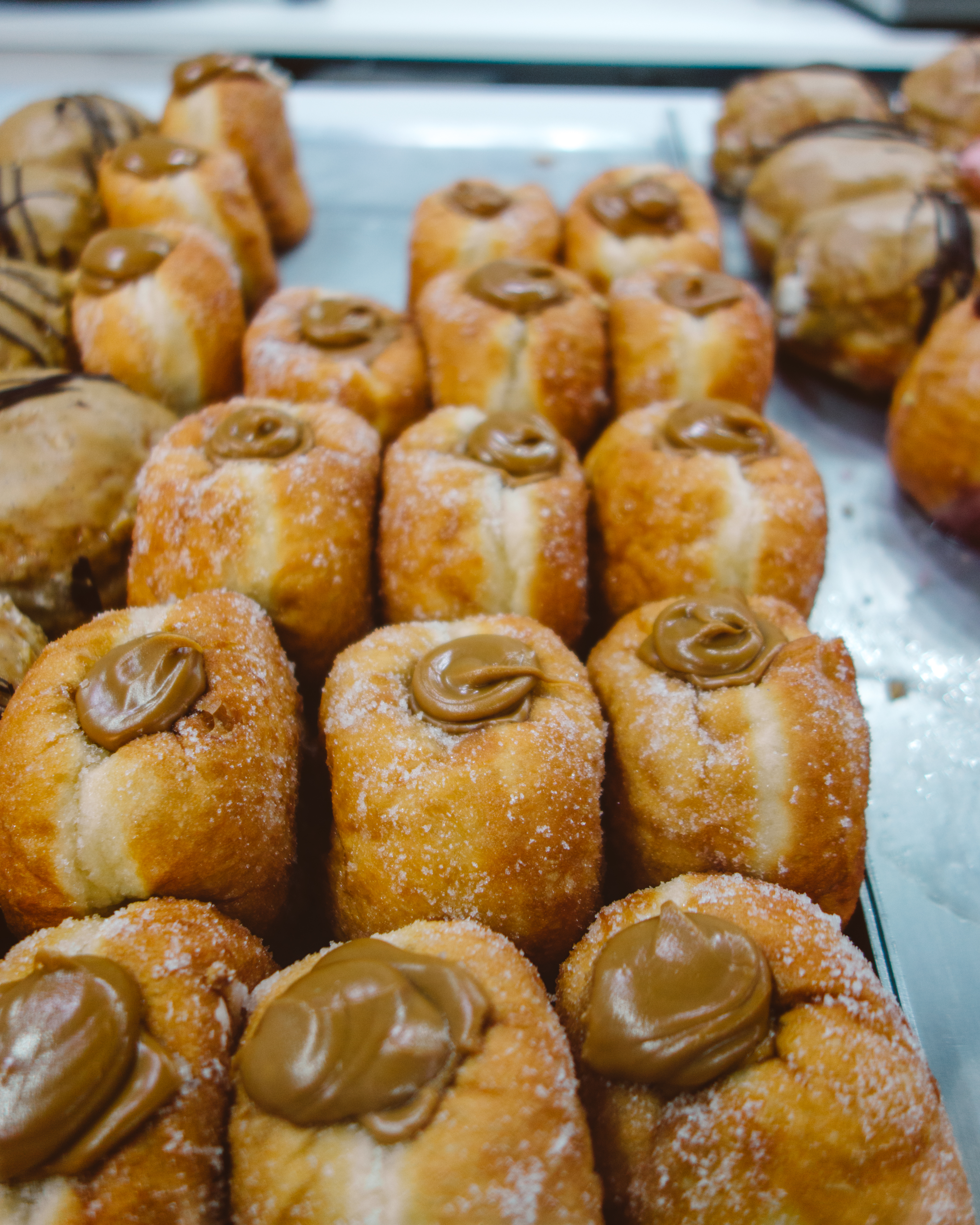 Rows of caramel doughnuts at Bruce and Luke's Coffee Shop, Keswick