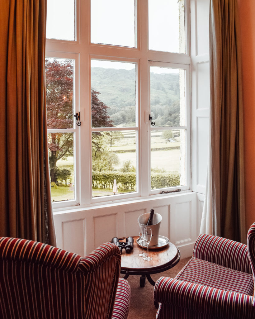 Two armchairs facing a window onto the fells at Lancrigg Hotel