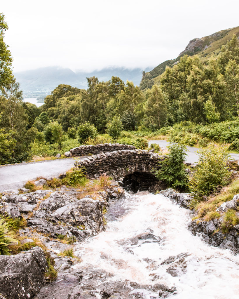 Small stone packhorse Ashness Bridge over rushing stream