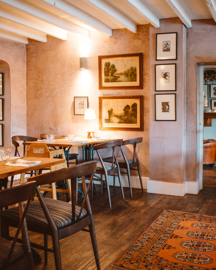 Stripped wooden floors and minimalist wooden tables inside the Drunken Duck Pub, Lake District