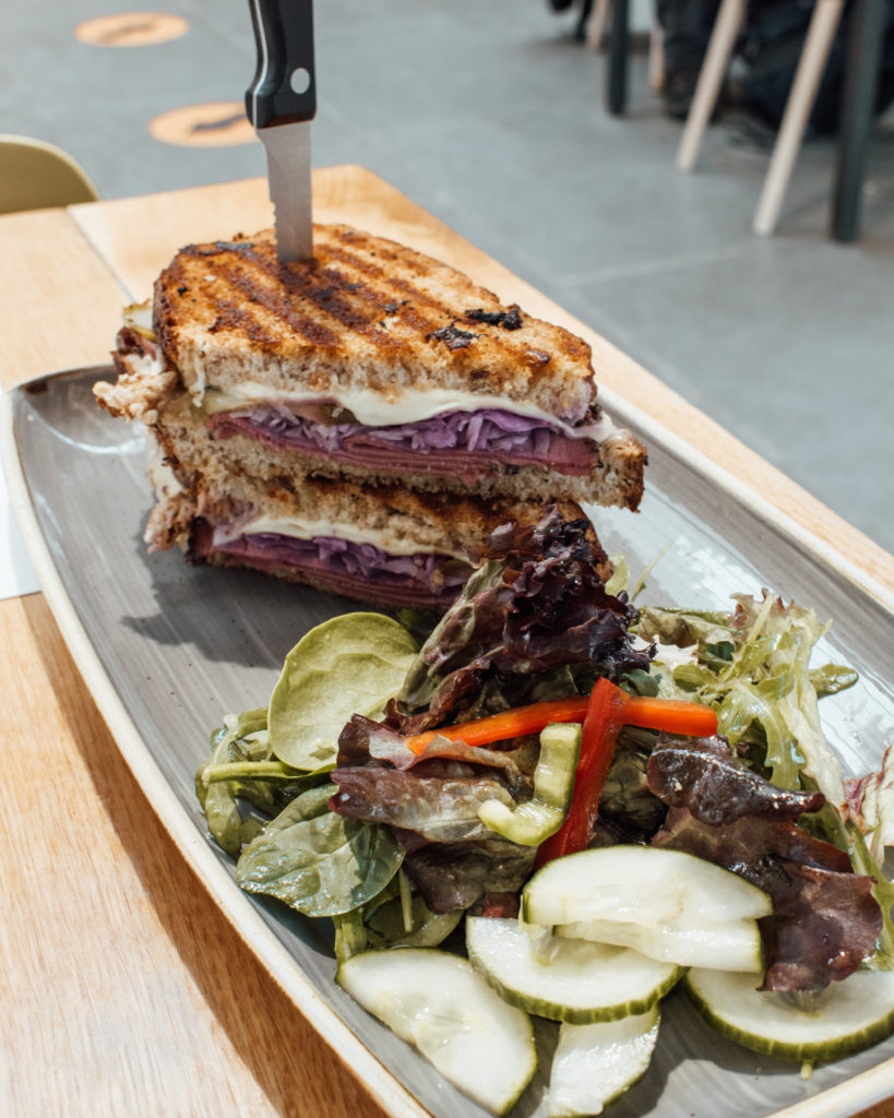 Huge Reuben sandwich with a knife jutting out of the top at Lingholm Kitchen and Garden
