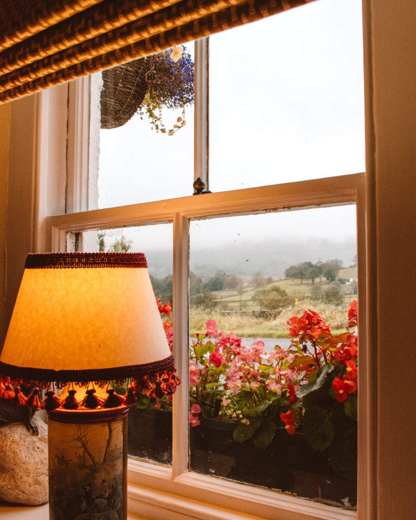 Cosy pub window looking out onto rainy fields at Traveller's Rest