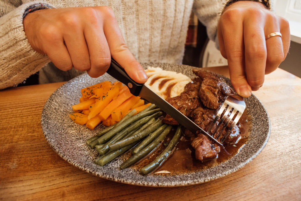 Lake District Foodie - Man eating Lamb Henry at the Traveller's Rest pub, just outside Grasmere