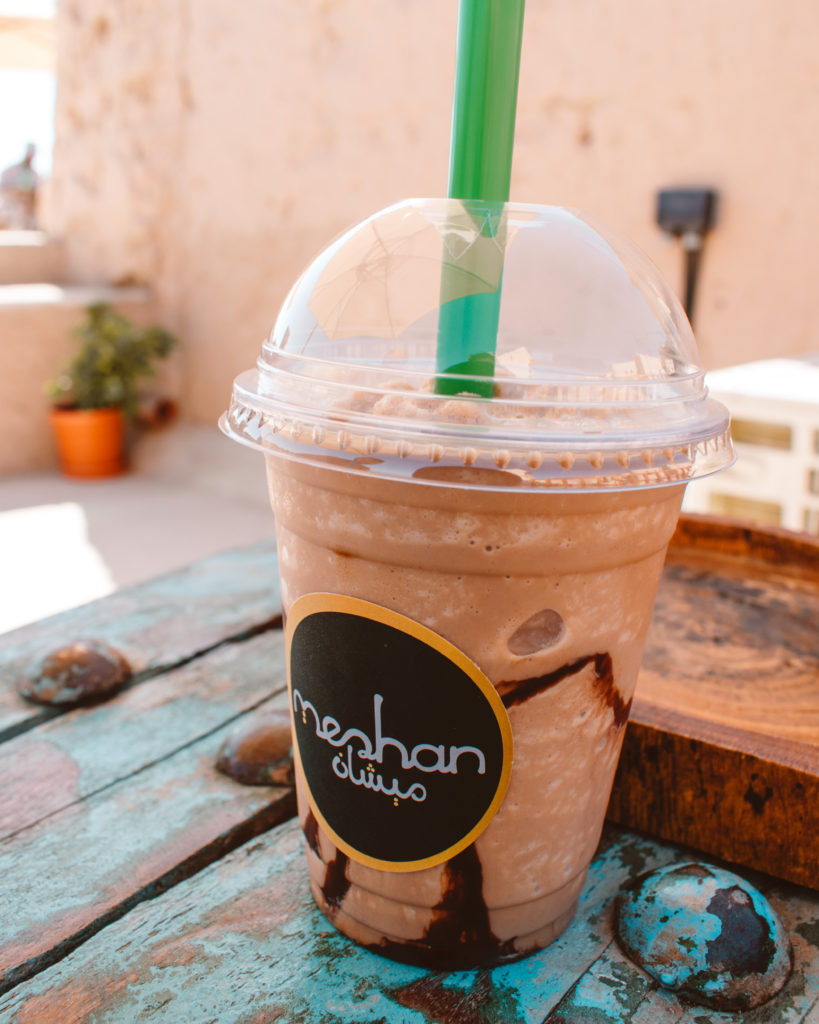 Iced coffee on a turquoise table at Bait al Sabah, Birkat al Mouz 