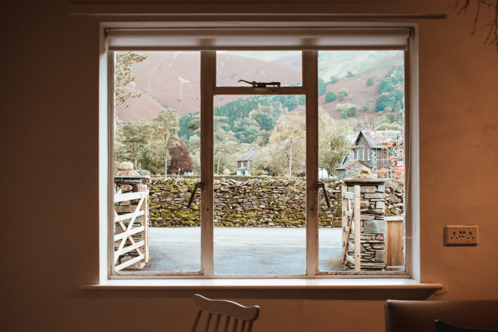 Window view onto a stone wall and the hills around Grasmere, at Mathilde's Cafe