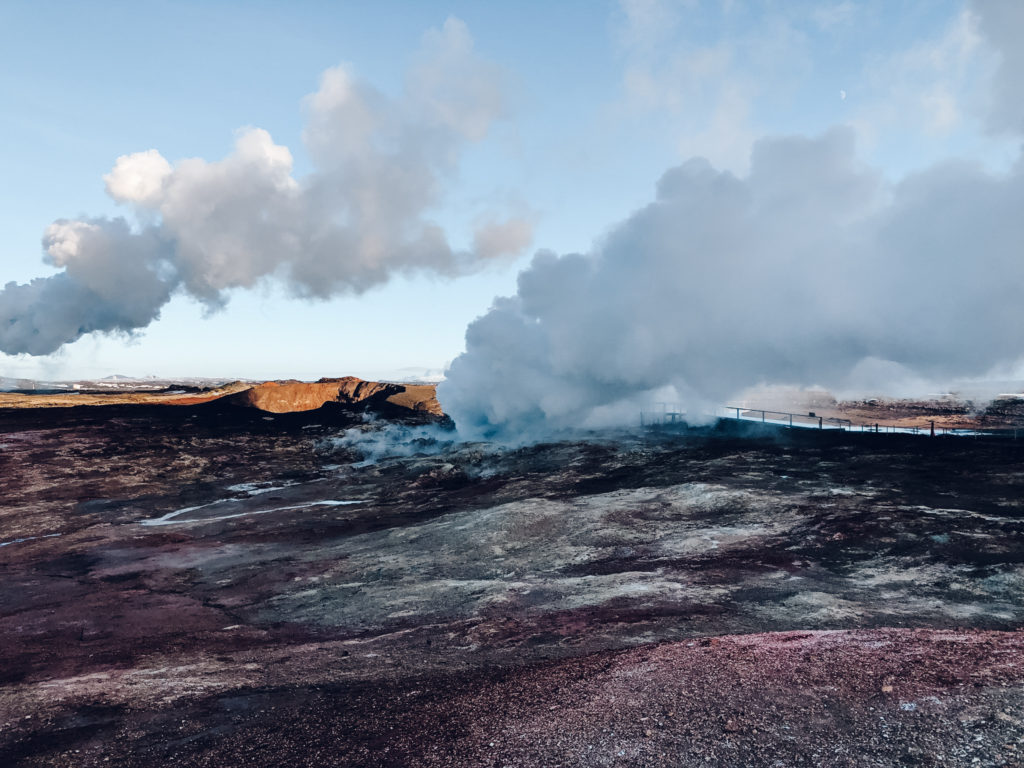 Geyser steam rising out of purple landscapes at Gunnuhver Geothermal Area