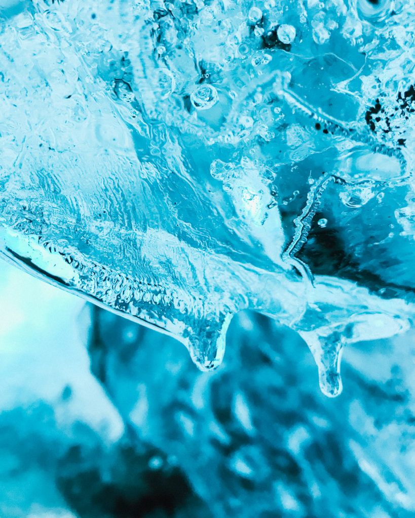 Luminous blue icicles inside an ice cave on Vatnajokull Glacier