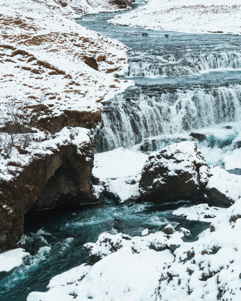 Frozen ground and snow covered waterfalls at Skogafoss