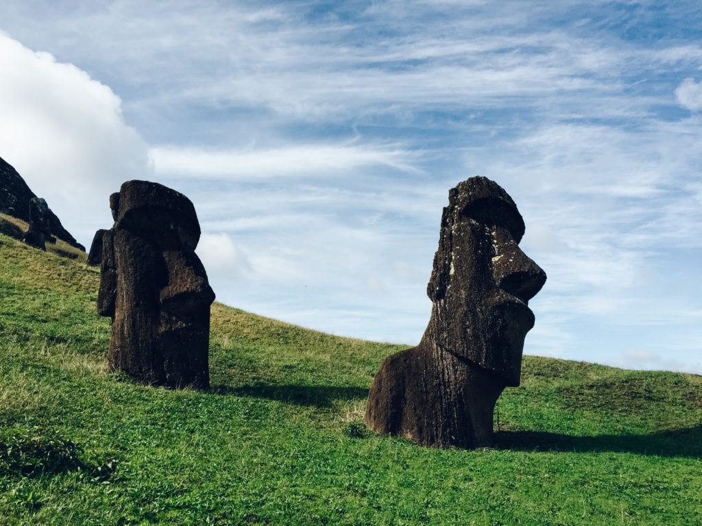 Moai heads sticking out of the grass at Rano Raraku