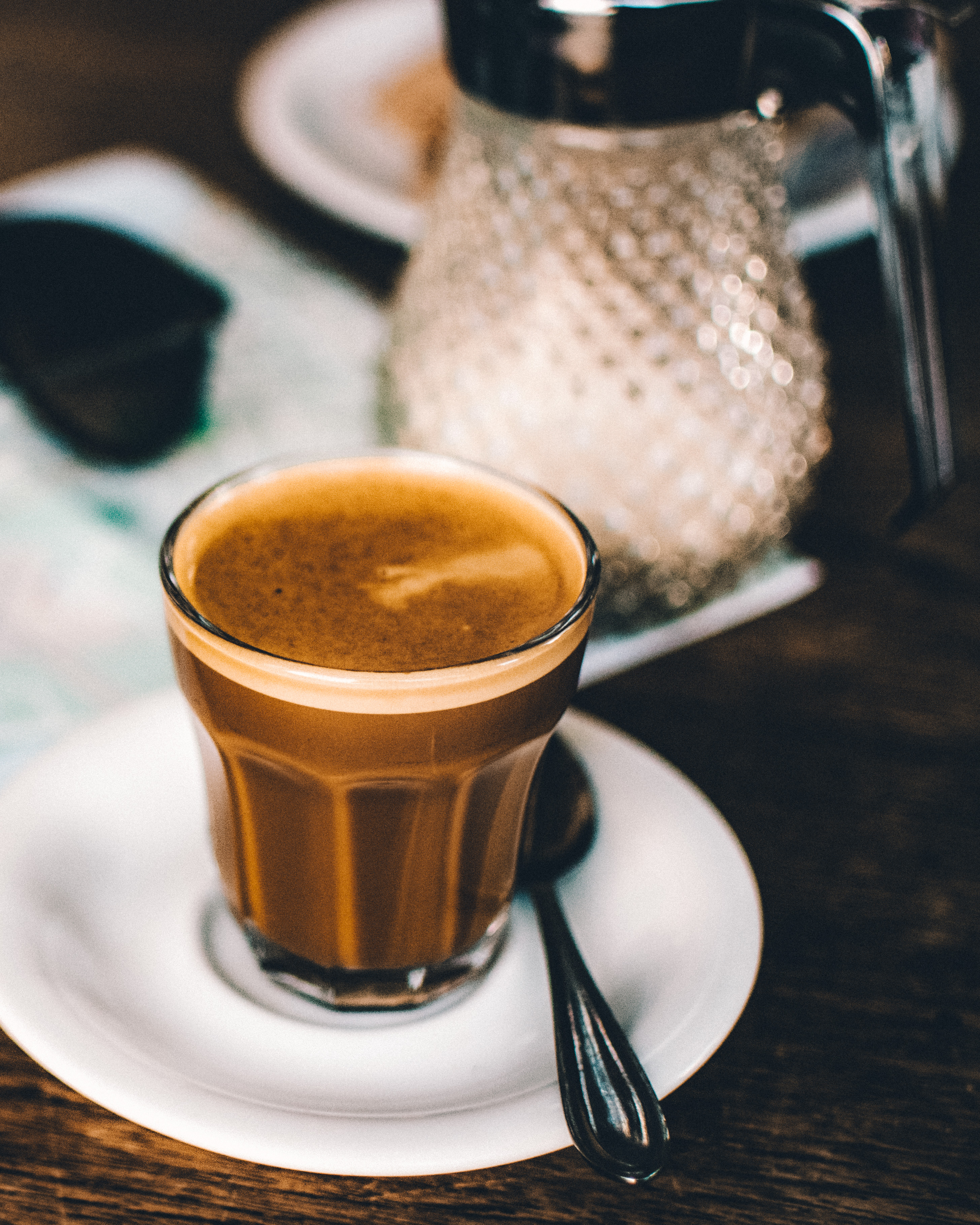 Coffee in a glass and sugar dispenser, at Reykjavik Roasters