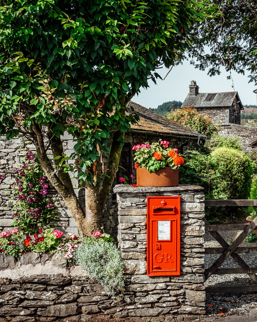 Red post box in a stone wall in Sawrey, Lake District