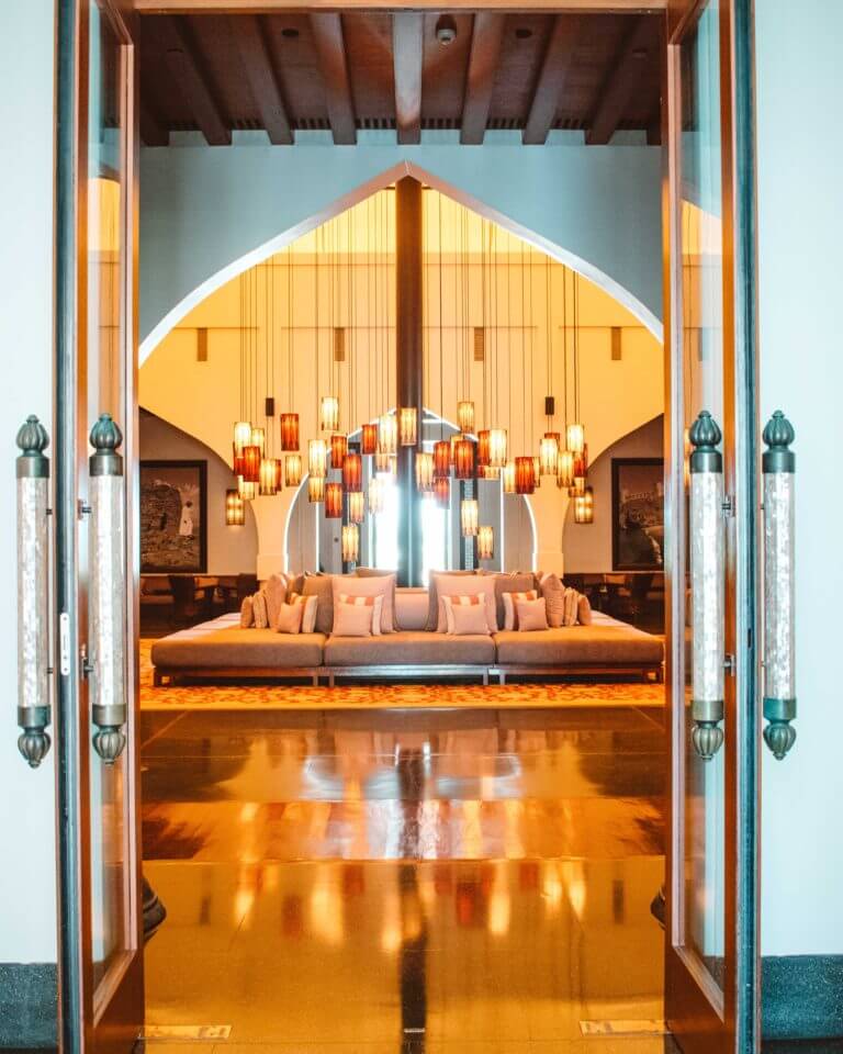 Hanging lanterns above a large sofa in the Beduin-style tent entrance lobby at The Chedi, Muscat