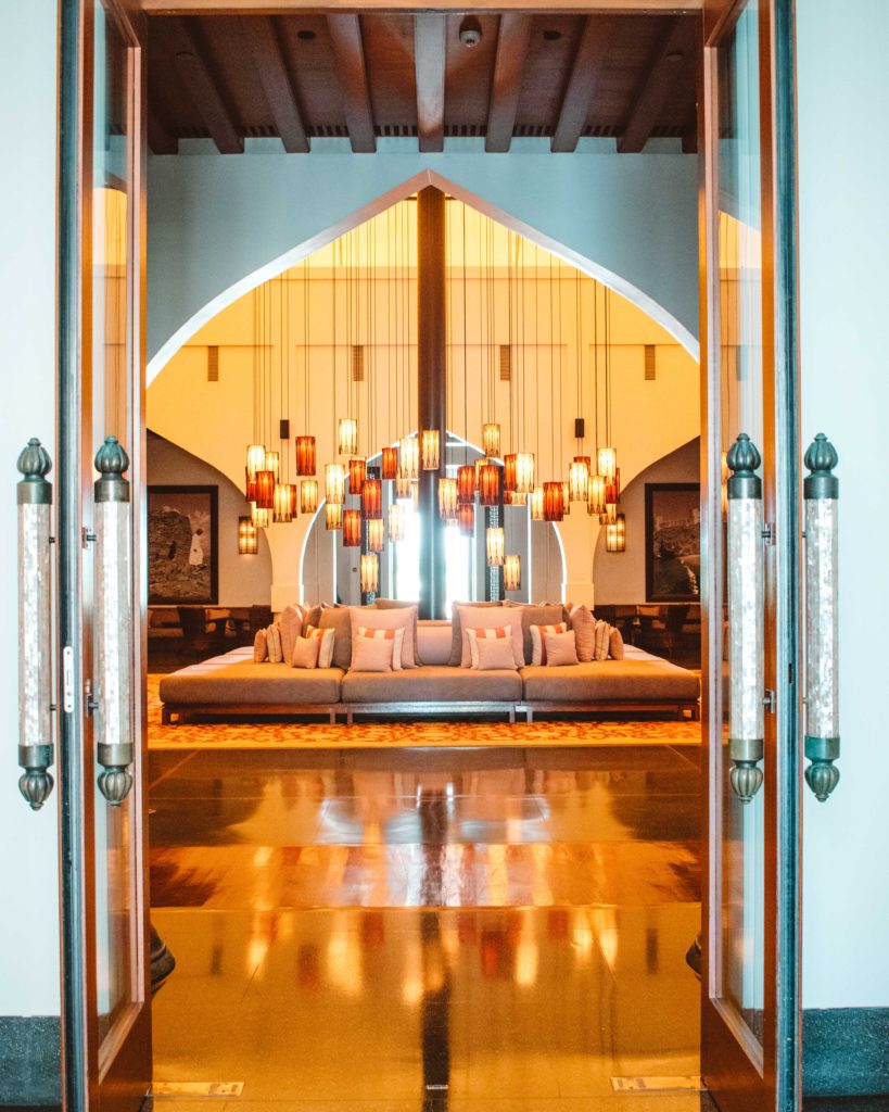 Hanging lanterns above a large sofa in the Beduin-style tent entrance lobby at The Chedi, Muscat