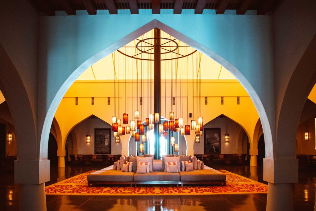Hanging lanterns above a large sofa in the Beduin-style tent entrance lobby at The Chedi, Muscat