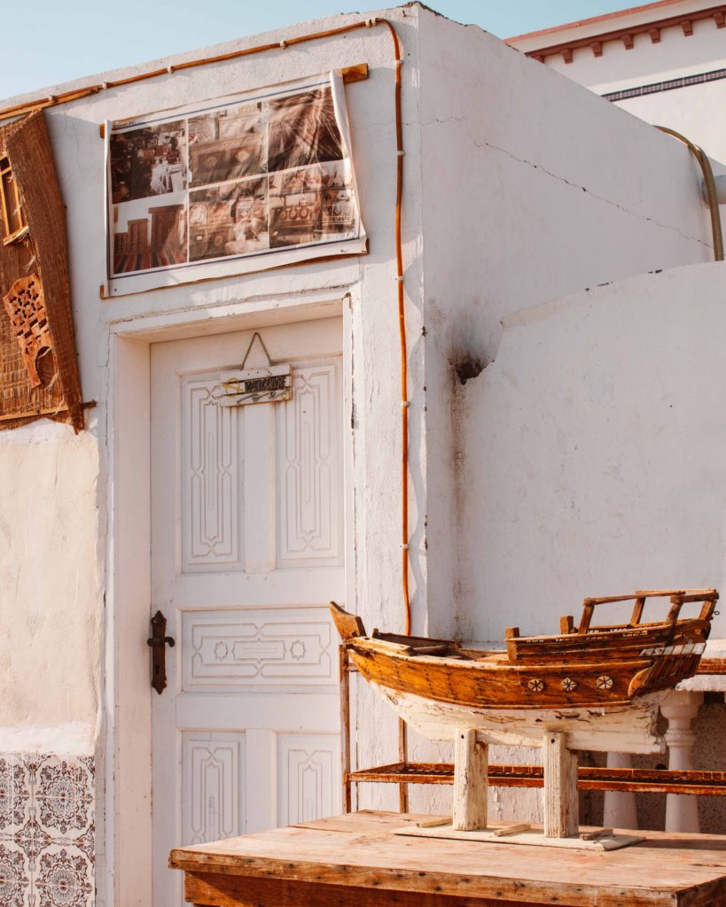 Small model of a wooden dhow, traditional Omani fishing boat, outside a shop in Sur