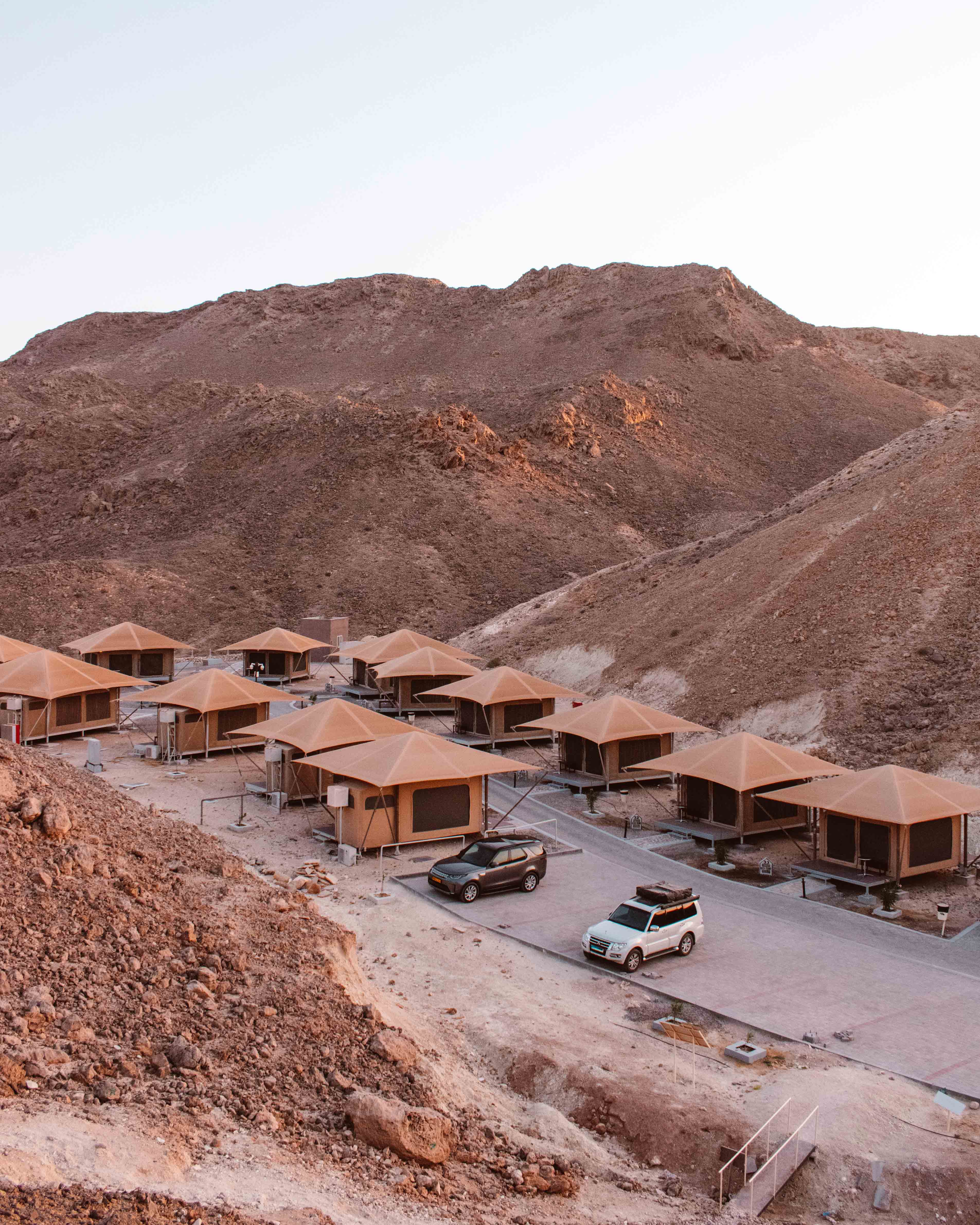 Eco tents at Ras Al Jinz Nature Reserve in dip better two rocky hillsides