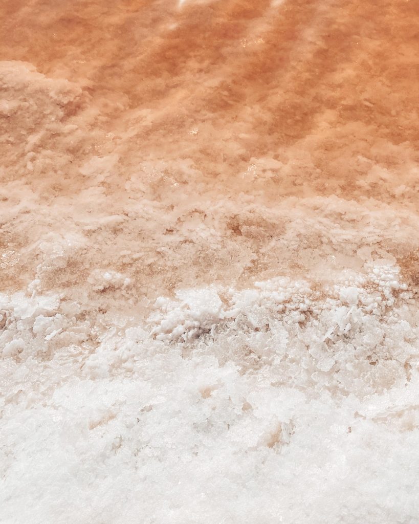 Pink water and crystals of salt at salt farm