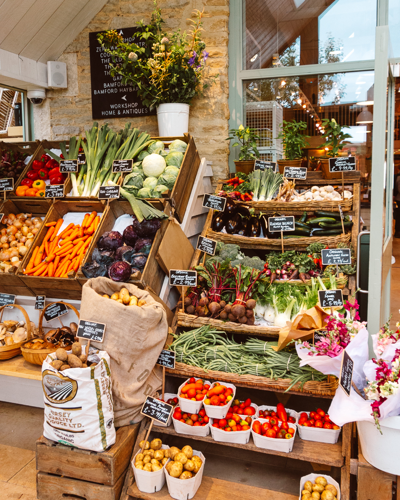 Fruit and vegetables displayed on wooden racks at the Daylesford Farm shop. 