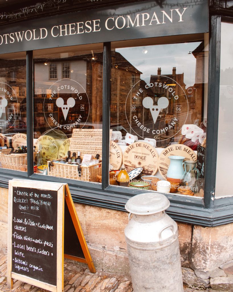 Cheese display in the window of the Cotswolds Cheese Company in Burford.