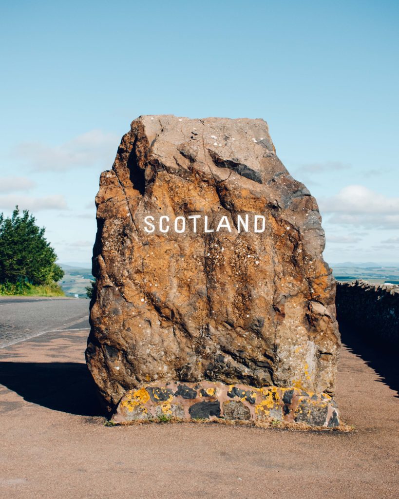 Large stone boulder imprinted with "Scotland" at the Carter Bar border between Scotland and England