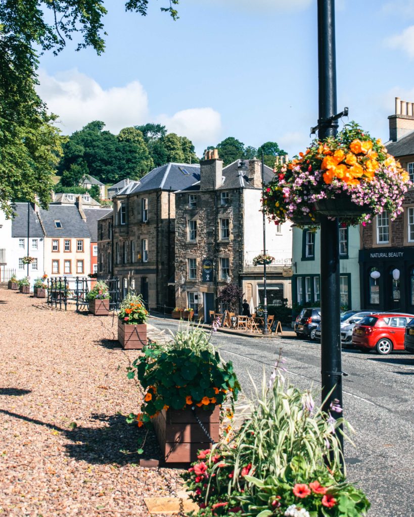 Colourful hanging baskets filled with flowers in Jedburgh