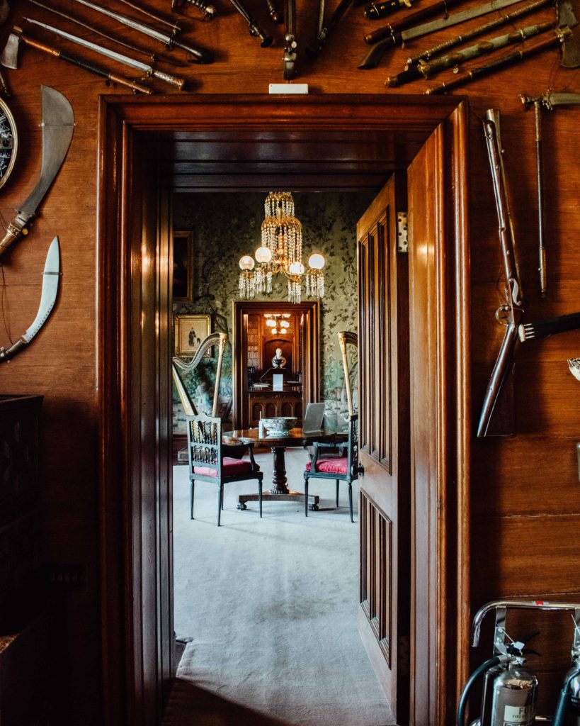 View through the formal rooms and displayed Scottish weaponry on the wall at Abbotsford, the home of Sir Walter Scott