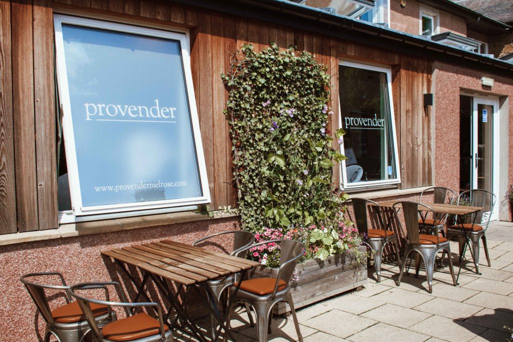 Wooden tables and chairs outside Provender restaurant in Melrose