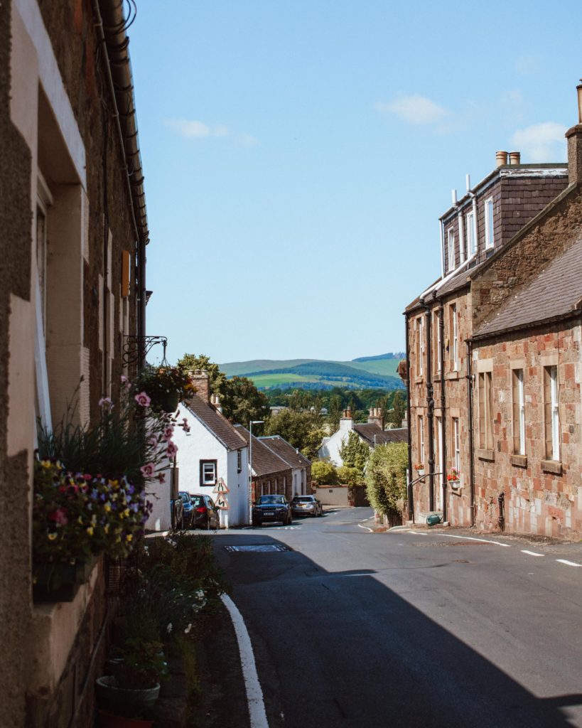 View down a road to the hills of The Scottish Borders beyond on a sunny day