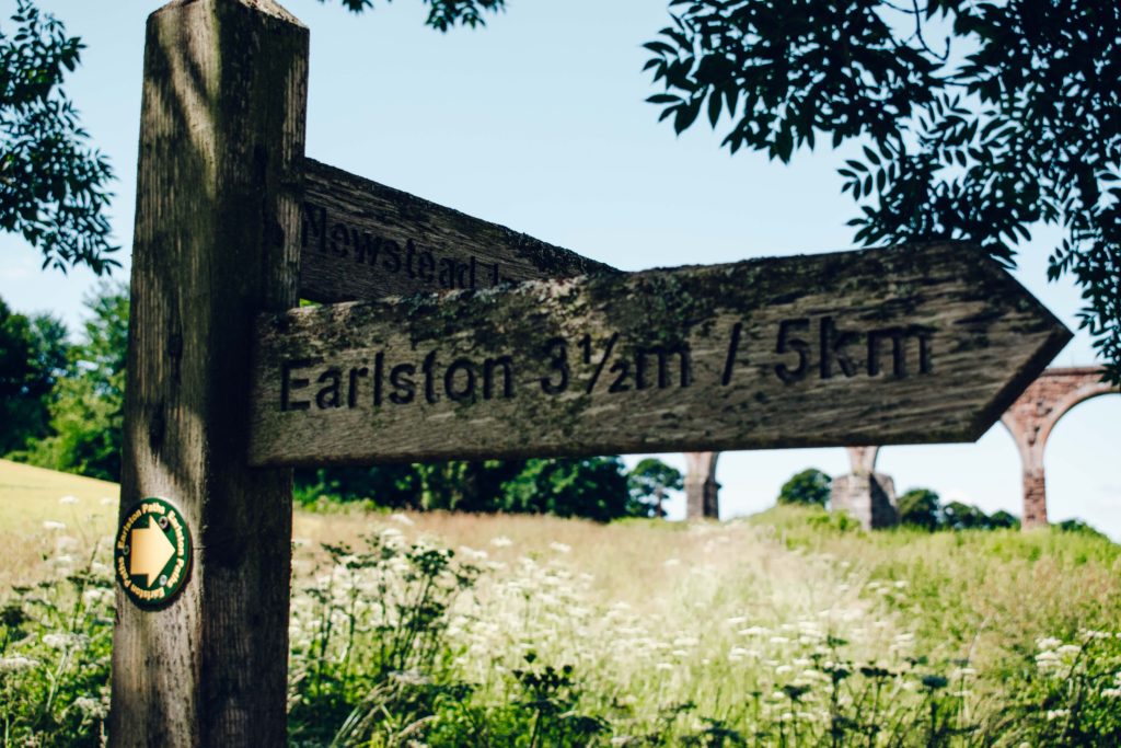 Sign post behind the Leaderfoot Viaduct in the Scottish Borders, pointing along the hiking and walking routes