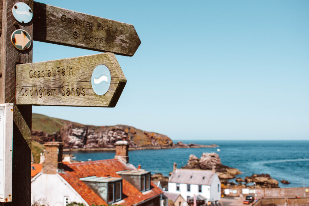Sign to the coastal path hiking and walking routes above St Abbs 