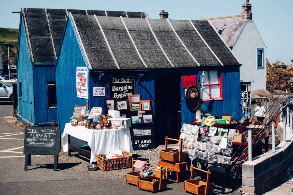 Small blue wooden shed selling souvenirs and gifts at St Abbs