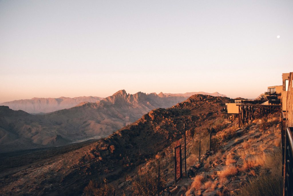 Sunrise and the moon over the Hajar Mountains and Jebel Shams from The View, Oman
