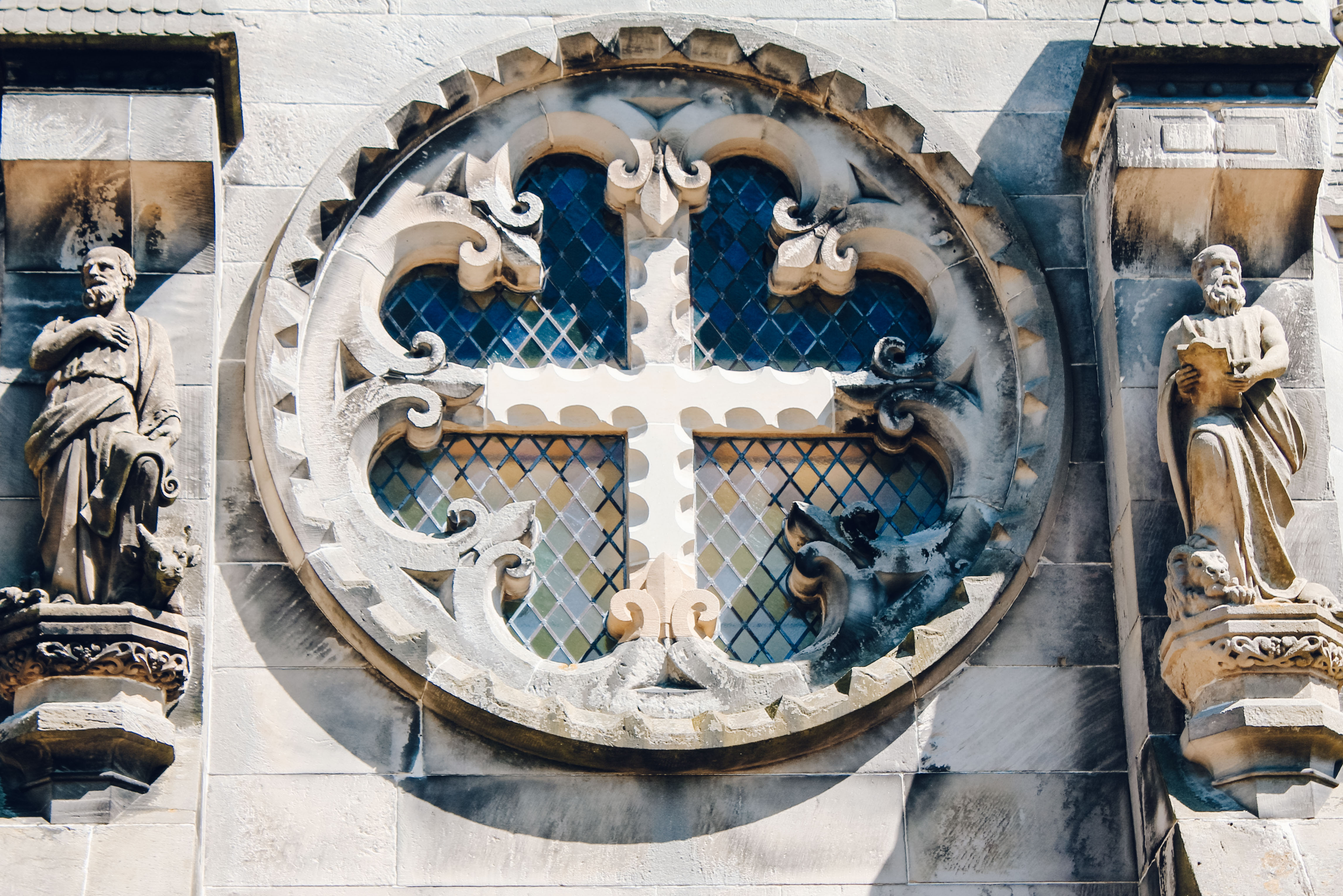 Intricately carved cross and window on the outside of Rosslyn Chapel, Midlothian