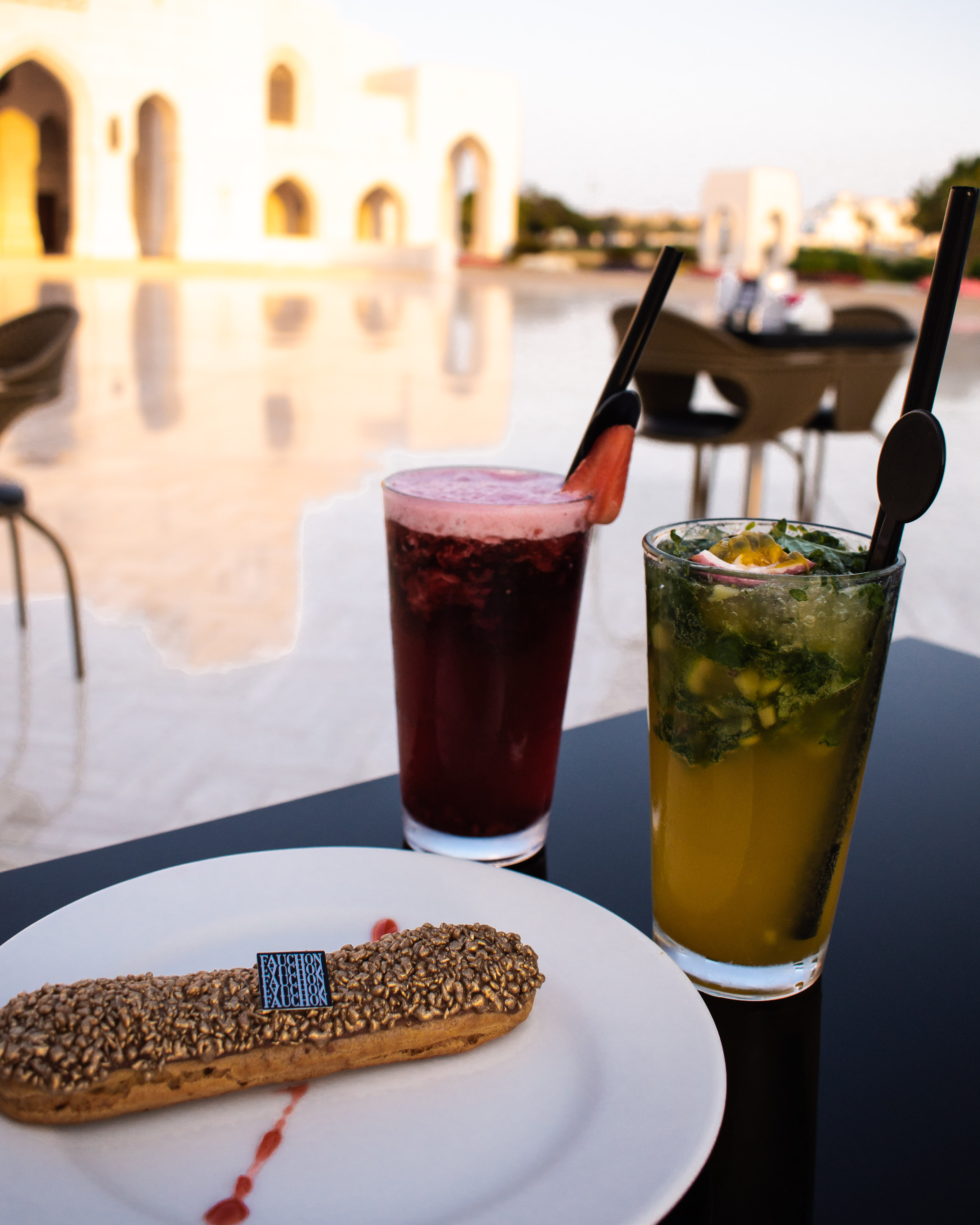 Chocolate eclair and two fruit juices from Fauchon, in front of the Muscat Royal Opera House